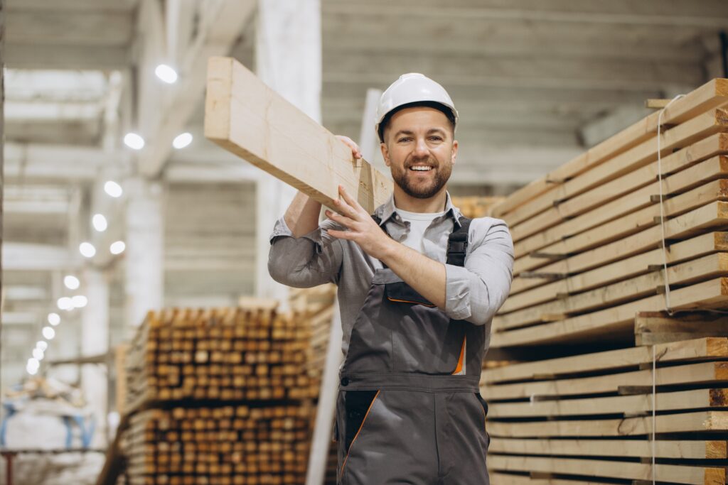 carpenter carrying wooden plank timber warehouse modular building